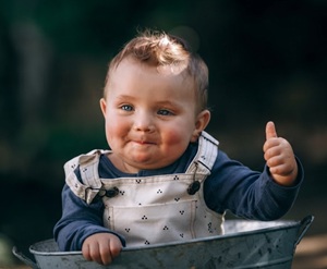 A baby giving a thumbs up